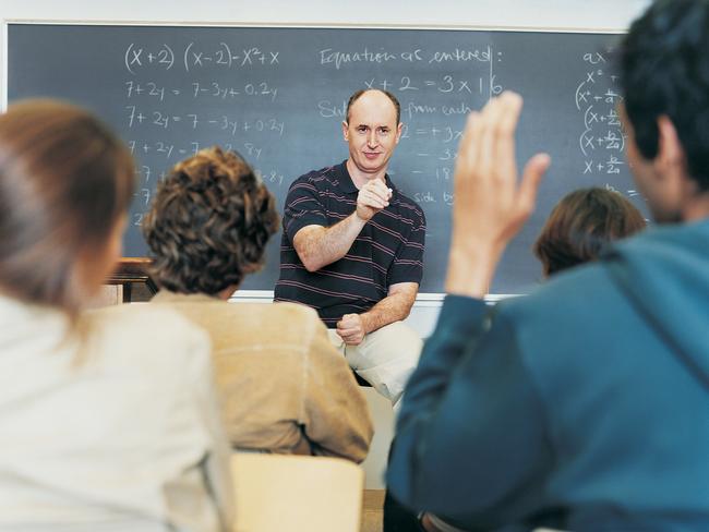 Male Teacher Asking Students Questions During Seminar. Teacher in classroom. Thinkstock