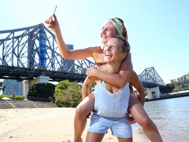 French tourists Segolene Dailler and Anais Collas taking photos around Brisbane. Photographer: Liam Kidston.