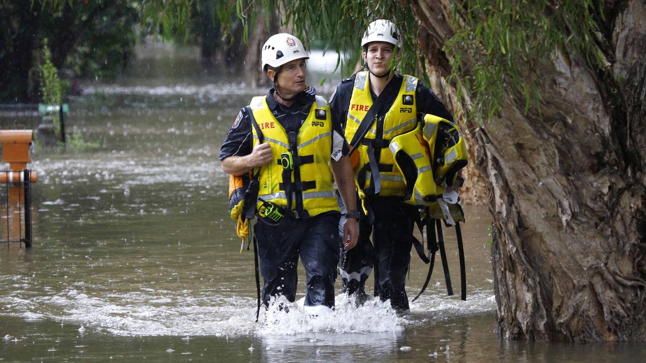 Emergency workers in floodwaters in Wilston. Picture: Tertius Pickard