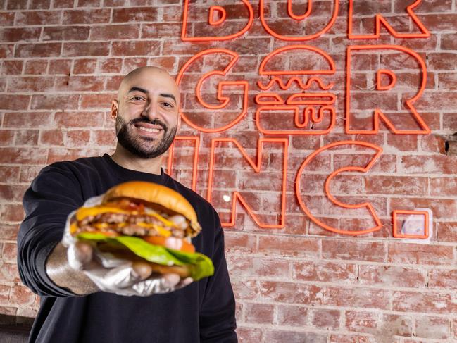 Owner of Burger Incredible Johnny Chaptini with one of his literally incredible burgers. Picture: Ben Clark