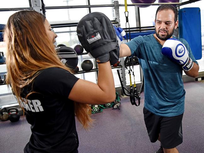 Under the pump: Anytime Fitness personal trainer Lucy Piper puts client Syed Ismail through his paces at Gladesville on Sunday. Picture: AAP Image / Troy Snook