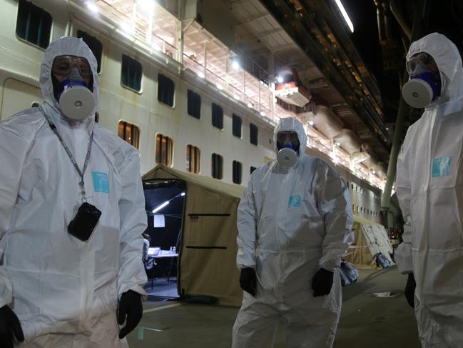 NSW Police wearing hazmat board the Ruby Princess cruise ship at Port Kembla on Wednesday night, April 8, 2020.Picture: NSW Police