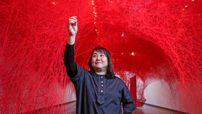 Chiharu Shiota with her installation called Uncertain Journey which is part of her exhibition at GOMA. Picture: Zak Simmonds