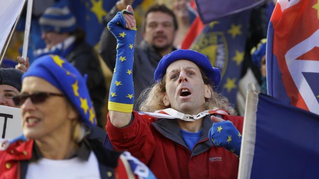 Anti Brexit campaigners demonstrate in Westminster in London, Monday, Nov. 19, 2018. The EU nations and Britain are still negotiating the outline text of a draft Brexit deal, setting out their future relationship which will have to be ratified by both the British and the European Parliaments. (AP Photo/Kirsty Wigglesworth)