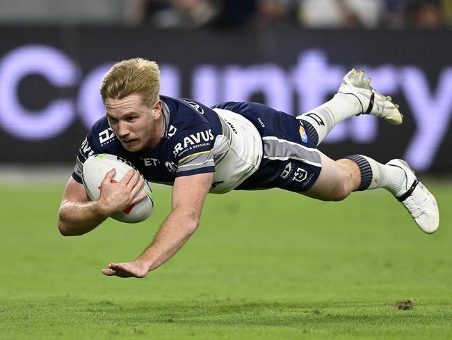 Tom Dearden of the Cowboys scores a try during the round 13 NRL match between North Queensland Cowboys and Wests Tigers. Picture: Ian Hitchcock/Getty Images.