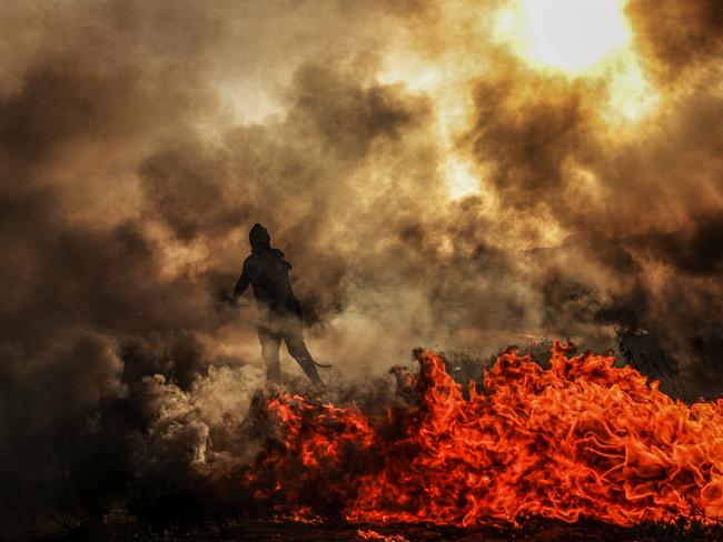 Palestinians set tires on fire and throw gas bombs during the demonstration that has been going on for a week against Israeli forces’ violations towards Al-Aqsa Mosque in Gaza Strip. Picture: Ali Jadallah/Anadolu Agency/Getty Images