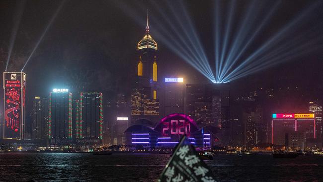 Pro-democracy protesters in a rally and revellers gather at the promenade of Tsim Sha Tsui district as fireworks explode over Hong Kong on January 1, 2020. Picture: Philip Fong/AFP