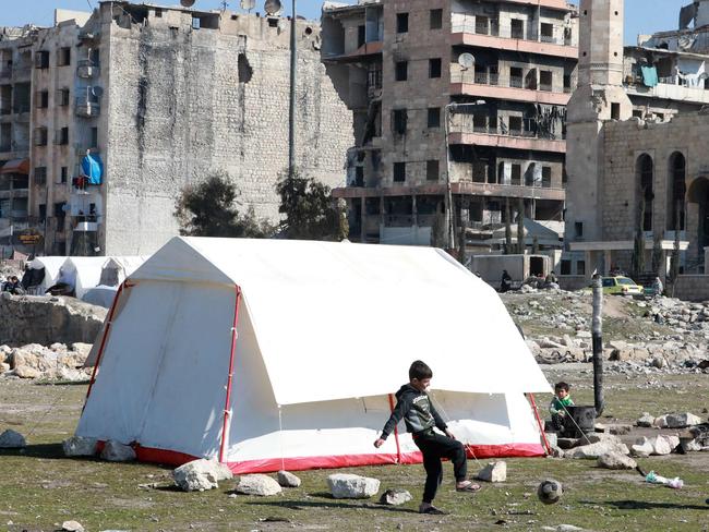 Children, displaced as a result of the earthquake play football outside a tent in the government-held northern city of Aleppo. Picture: AFP