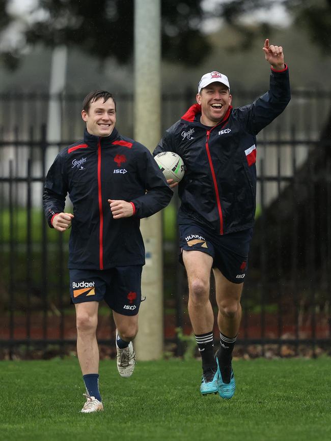 Luke Keary and Mitchell Aubusson during Sydney Roosters training at a rain-soaked Kippax oval on Monday. Picture: Phil Hillyard