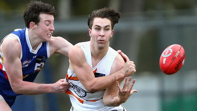 Rhylee West fires off a handball during a TAC Cup match.