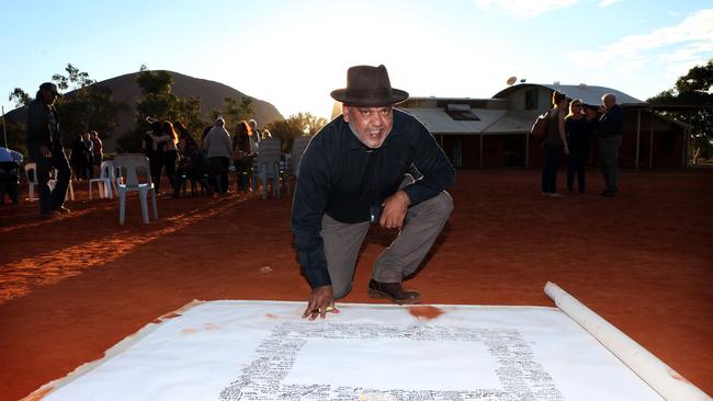 Noel Pearson signs the Uluru Statement which will be presented to parliament at the closing ceremony of the Indigenous Constitutional Convention held at Mutujulu. Picture: James Croucher