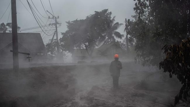 A member of a search and rescue team checks the situation at the Kajar Kuning village in Lumajang. Picture: AFP