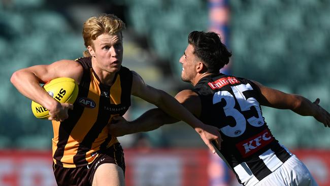 Cam Mackenzie breaks a Nick Daicos tackle in Launceston. Picture: Steve Bell/Getty Images