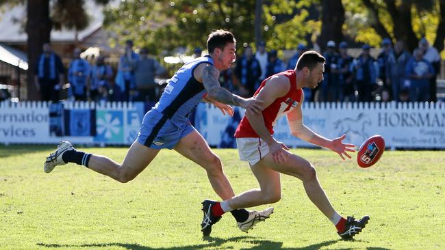 Sturt’s Jake Sutcliffe chases down North’s Cameron Graig at Prospect Oval. Picture: AAP/Emma Brasier