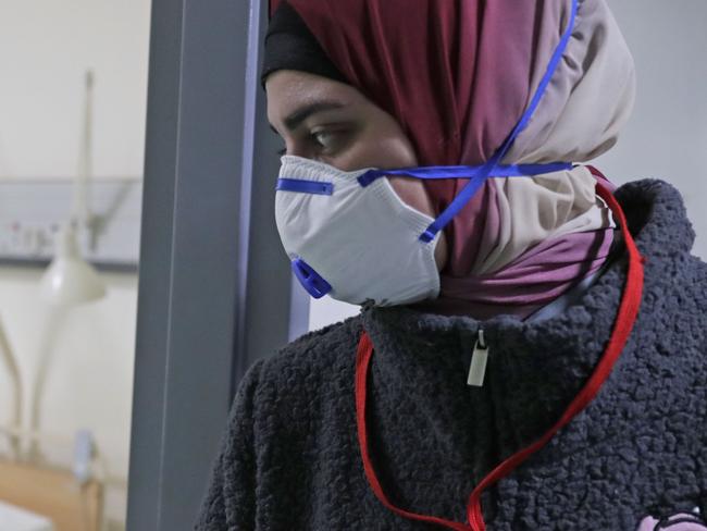 TOPSHOT - A Lebanese employee wearing a protective mask looks at a bed in a ward where the first case of  coronavirus in the country is being treated, at the Rafik Hariri University Hospital in the southern outskirts of the capital Beirut, on February 22, 2020. - Lebanon confirmed on February 21, the first case of the novel coronavirus, found in a 45-year-old Lebanese woman who had travelled from the holy city of Qom in Iran, while two other cases were being investigated. (Photo by ANWAR AMRO / AFP)