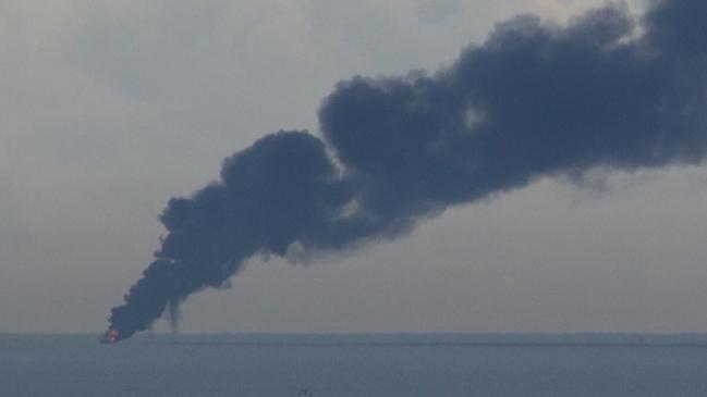 Smoke billows from the boat which went up in flames in waters off the Gold Coast. Supplied picture taken from Burleigh Heads. Picture: Steve O’Ferrall.