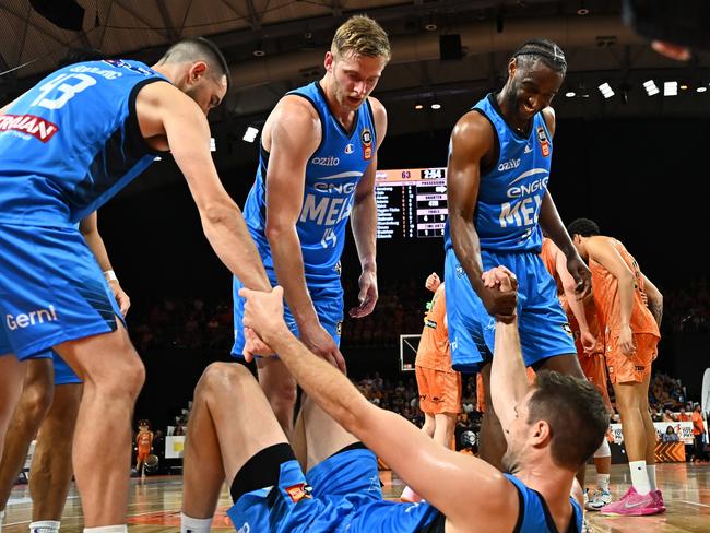 Rob Loe of United is assisted to his feet by teammates during the round 14 NBL match between Cairns Taipans and Melbourne United at Cairns Convention Centre, on December 26, 2024, in Cairns, Australia. (Photo by Emily Barker/Getty Images)