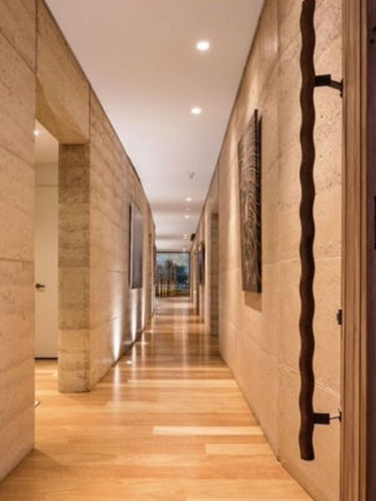 The rammed earth walls store heat.