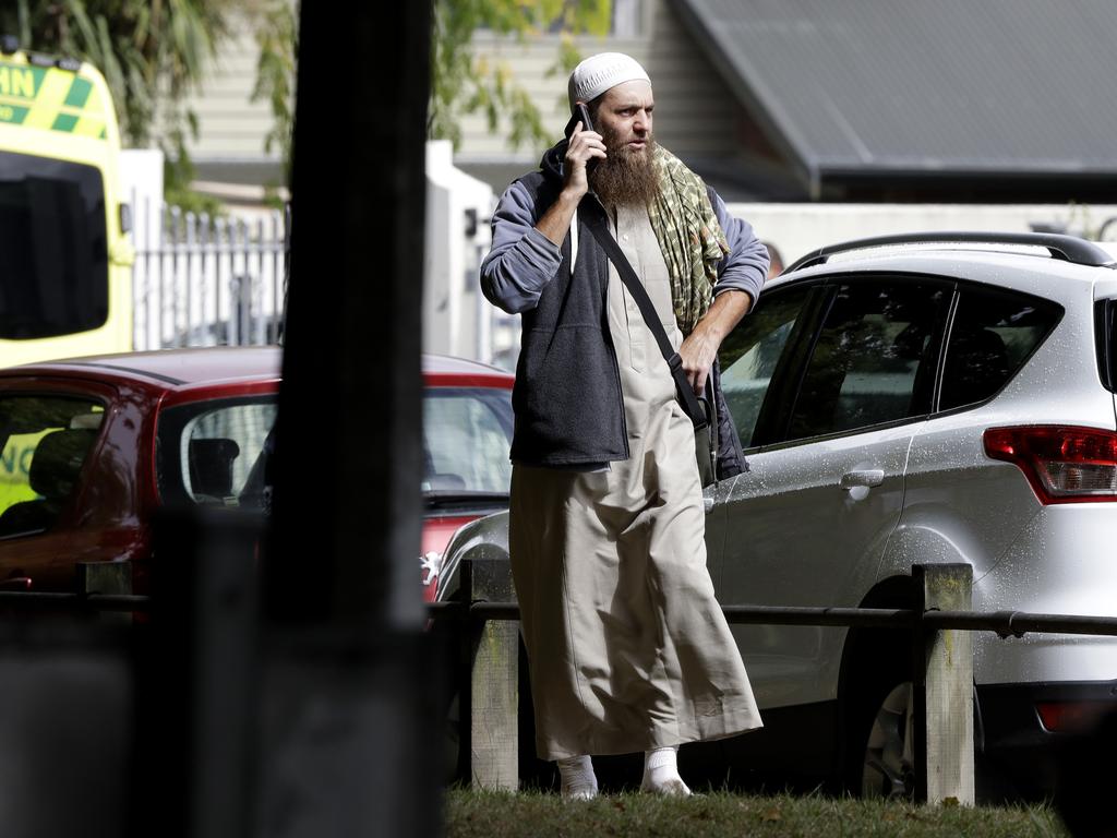 A man talks on his mobile phone across the road from a mosque in central Christchurch, New Zealand, Friday, March 15, 2019. (AP Photo/Mark Baker)