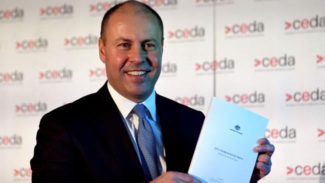 Josh Frydenberg with a copy of the 2021 Intergenerational Report in Melbourne on Monday. Picture: AFP