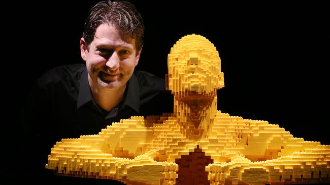 THE ART OF BRICK EXHIBITION .. LONDON, ENGLAND - SEPTEMBER 24: Artist Nathan Sawaya stands with his sculpture 'Yellow' at the Art of Brick Exhibition on September 24, 2014 in London, England. Eighty sculptures by artist Nathan Sawaya are on display at The Old Truman Brewery. Created from a million Lego bricks, the exhibition opens on September 26, 2014 and runs until January 4, 2015. (Photo by Peter Macdiarmid/Getty Images)