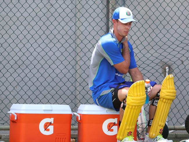 Chris Lynn rubs his shoulder after batting in the nets during Australian cricket team training.