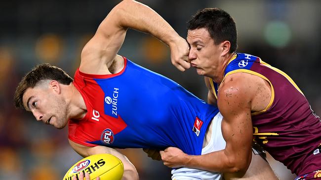 Jack Viney attempts to handball while tackled by Hugh McCluggage. Picture: Albert Perez/AFL Photos via Getty Images