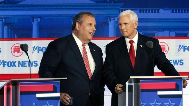 Chris Christie and Mike Pence speak during a break.