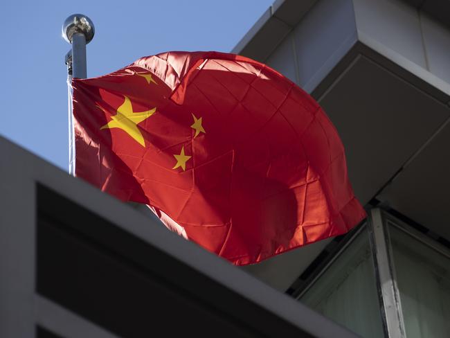 A Chinese national flag waves at the Chinese consulate after the United States ordered China to close its doors. Picture: AFP