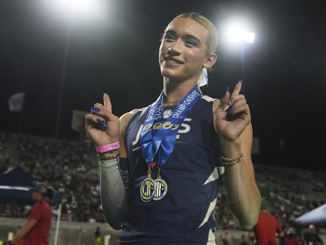 AB Hernandez, a transgender student at Jurupa Valley High School, poses for photos with her medals at the California high school track-and-field championships in Clovis, California. Picture: AP Photo/Jae C. Hong