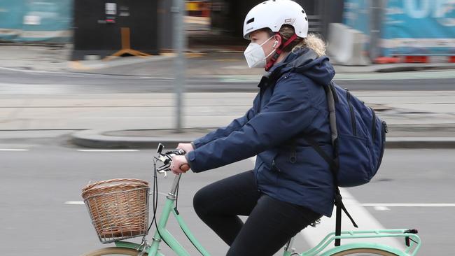 A cyclist wear a mask in Melbourne’s CBD. Picture: David Crosling/NCA NewsWire.