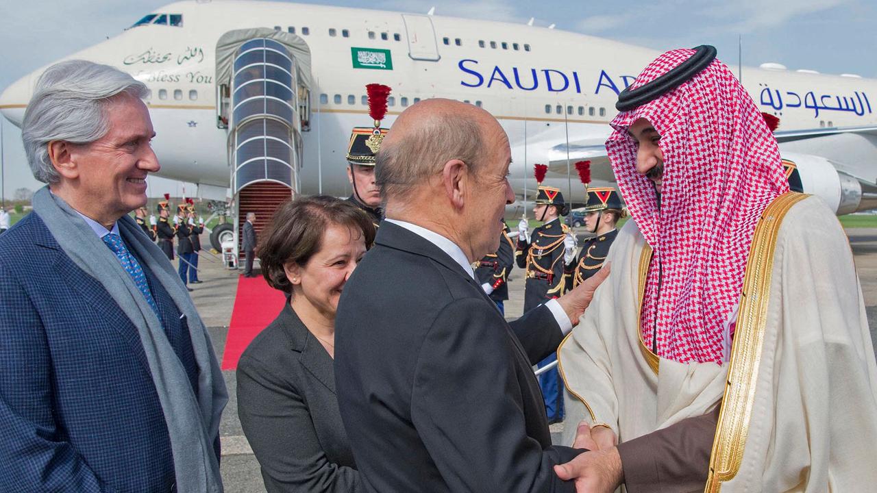 CORRECTION - French Foreign Affairs Minister Jean-Yves Le Drian (2nd-R) welcomes Saudi Arabia's crown prince Prince Mohammed bin Salman (1st-R) next to  French Ambassador to Saudi Arabia Francois Gouyette (1st-L) at Le Bourget airport, north of Paris, on April 8, 2018. Saudi Arabia's crown prince Prince Mohammed bin Salman arrived in France on April 8, for the next leg of a global tour aimed at reshaping his kingdom's austere image as he pursues his drive to reform the conservative petrostate. / AFP PHOTO / Saudi Royal Palace / BANDAR AL-JALOUD / RESTRICTED TO EDITORIAL USE - MANDATORY CREDIT "AFP PHOTO / SAUDI ROYAL PALACE / BANDAR AL-JALOUD" - NO MARKETING - NO ADVERTISING CAMPAIGNS - DISTRIBUTED AS A SERVICE TO CLIENTS / “The erroneous mention[s] appearing in the metadata of this handout photo by the Saudi Royal Palace has been modified in AFP systems in the following manner: [Saudi Royal Palace] instead of [Ahmed Nureldine]. Please immediately remove the erroneous mention[s] from all your online services and delete it (them) from your servers. If you have been authorized by AFP to distribute it (them) to third parties, please ensure that the same actions are carried out by them. Failure to promptly comply with these instructions will entail liability on your part for any continued or post notification usage. Therefore we thank you very much for all your attention and prompt action. We are sorry for the inconvenience this notification may cause and remain at your disposal for any further information you may require.”