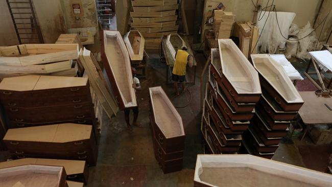 Employees work at Viana Funeral services to meet the increased demand. Picture: AFP.