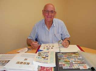 STAMPED: Peter Rule tending to his impressive stamp collection. Picture: Eden Boyd