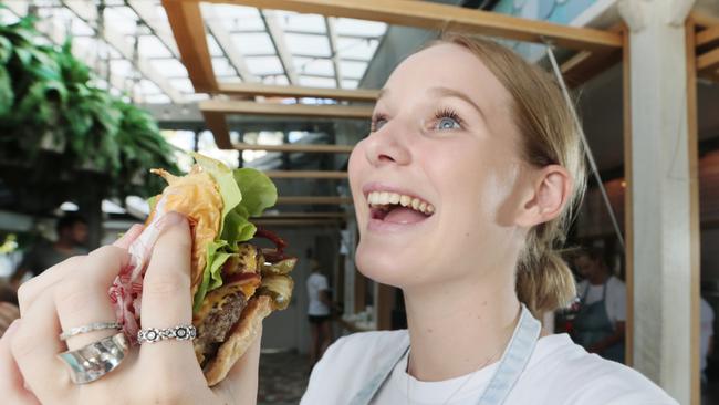 Staff member Phoebe Cooney gets ready to tuck in at Bettys Burgers. Photo Lachie Millard