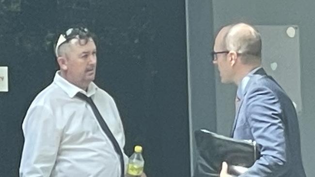 Corey Dobson, 44, (white shirt) talks to his lawyer outside Wyong Local Court where he was sentenced to an ICO for 15 months for drugs, weapons and fireworks offences. Picture: NewsLocal