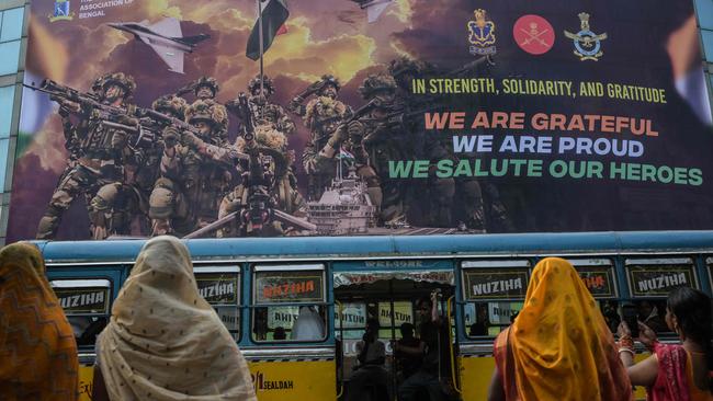 People look at a hoarding hung on the main gate of Eden Gardens in Kolkata, acknowledging the efforts of the Indian armed forces during the recent India-Pakistan conflict. Picture: Dibyangshu Sarkar / AFP