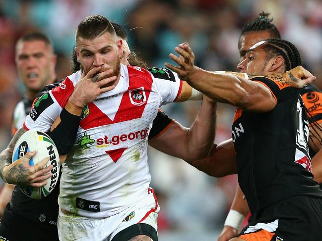 SYDNEY, AUSTRALIA - SEPTEMBER 05: Josh Dugan of the Dragons is tackled during the round 26 NRL match between the St George Illawarra Dragons and the Wests Tigers at ANZ Stadium on September 5, 2015 in Sydney, Australia. (Photo by Cameron Spencer/Getty Images)