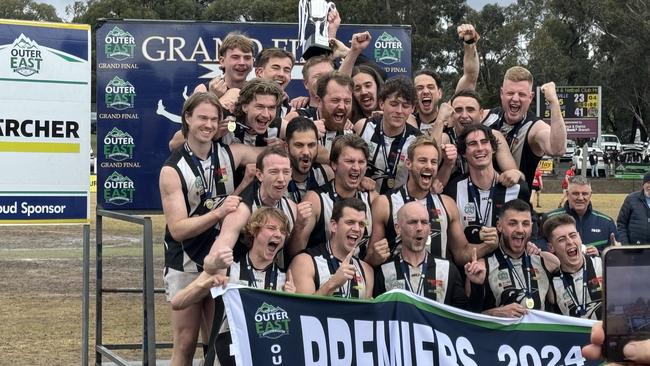 Belgrave show off the reserves premiership flag.