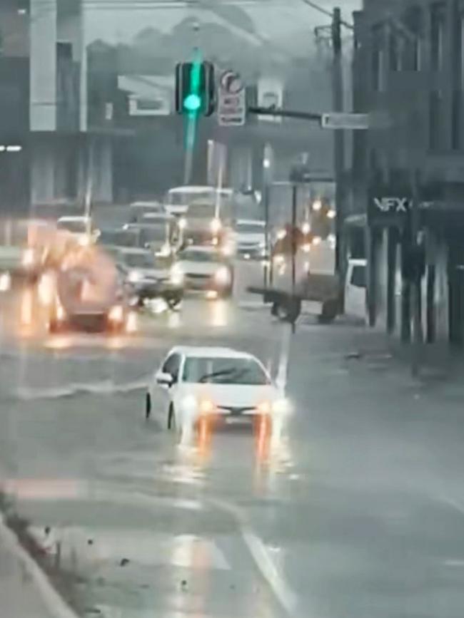 Flooding on Parramatta Road cross of Flood Street. Picture James Silver