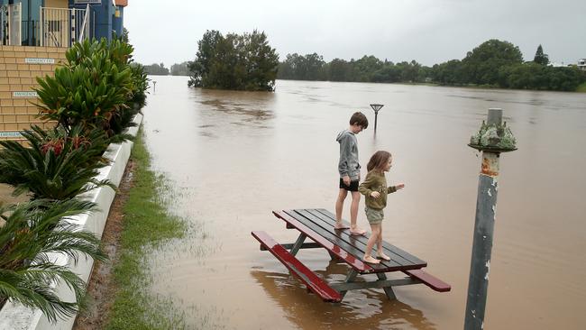 Heavy rain continues to batter the Mid-North Coast causing major flooding. Kempsey residents check the water levels at the towns levy wall. Picture: Nathan Edwards