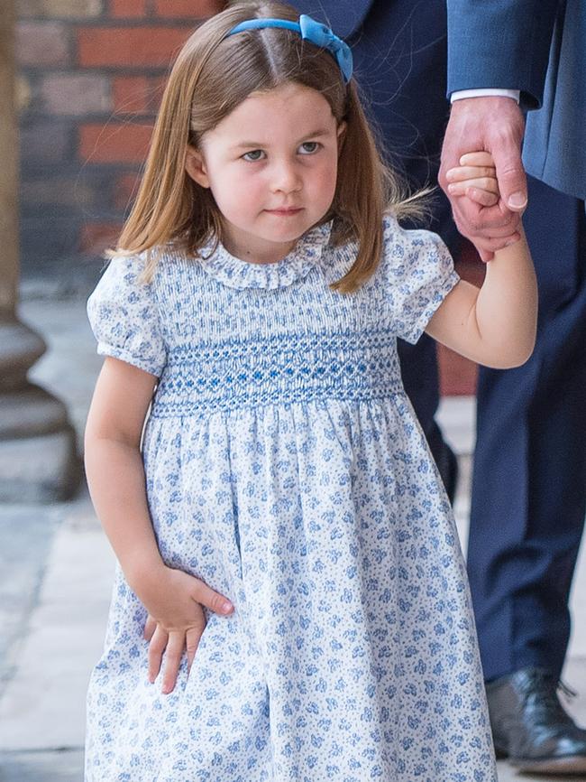 Princess Charlotte was dressed in a signature smocked frock, this one probably from Amaia Kids, for her brother’s christening this week. Picture: Mega