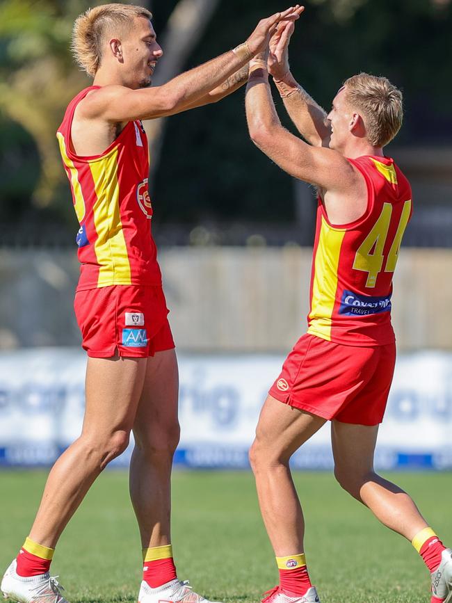 Joel Jeffrey (left) celebrates a goal before finishing with a stunning nine majors in the VFL round 15 match against Aspley Hornets at Graham Road Oval on July 24. Picture: Russell Freeman/AFL Photos via Getty Images