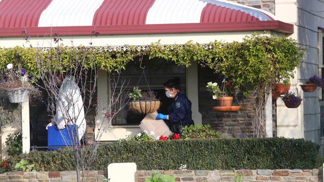 Police remove potential evidence from the home.