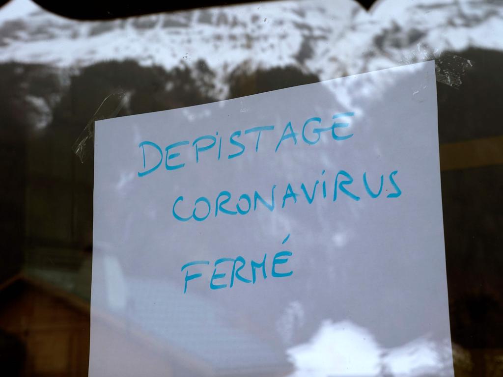 A sign reads ‘No screenings. In case of symptom dial 15’ in a window in Les Contamines-Montjoie, near Mont Blanc in the French Alps. Picture: Alex Martin/AFP