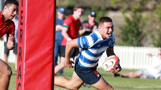 Nudgee no. 10 Reesjan Pasitoa scores a try vs Gregory Terrace in last year’s competition. File picture