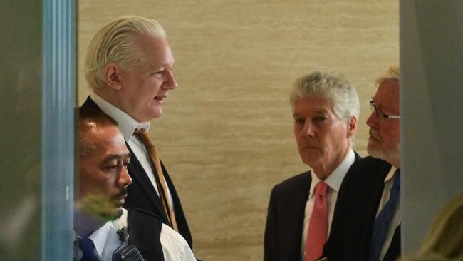 WikiLeaks founder Julian Assange (L) arrives for a court hearing at the US Federal Courthouse on Saipan. Picture: AFP.