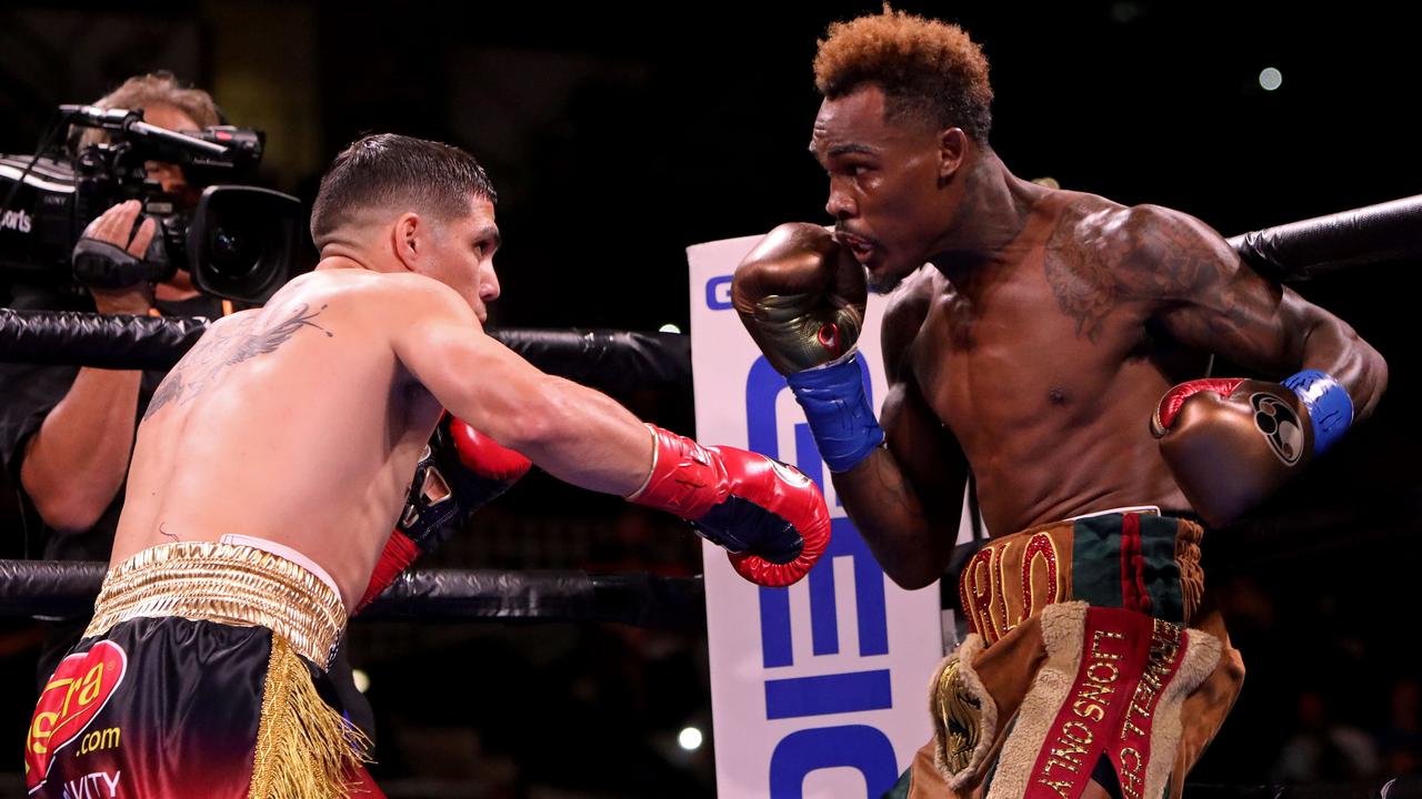 Jermell Charlo (R) and Brian Castano (L) exchange punches.