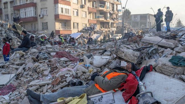 A worker sleepson the rubble in Hatay. Picture: AFP.