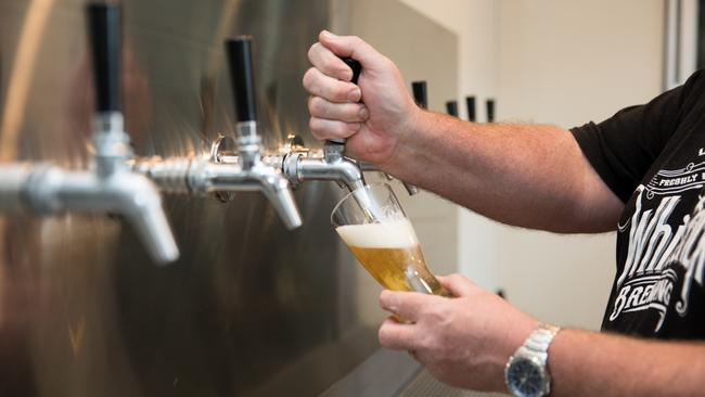 Adam Gibb pulls a beer at White Brick Brewing. Photo: Dominika Lis.